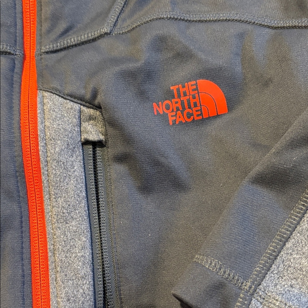 The North Face Black Jacket with Red Logo and Red Zipper Accents